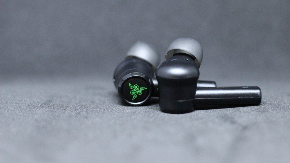The Razer Hammerhead Pro earbuds with a focus on the touchpad and Razer triple snake logo