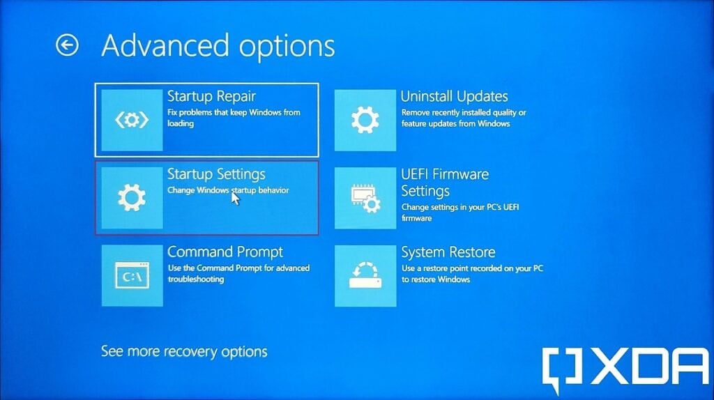 Windows 11 UEFI menu with Startup settings option highlighted to boot into Safe Mode