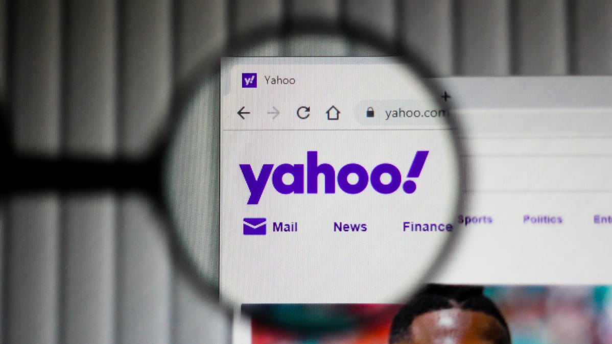 Yahoo logo in website header inside a magnifying glass