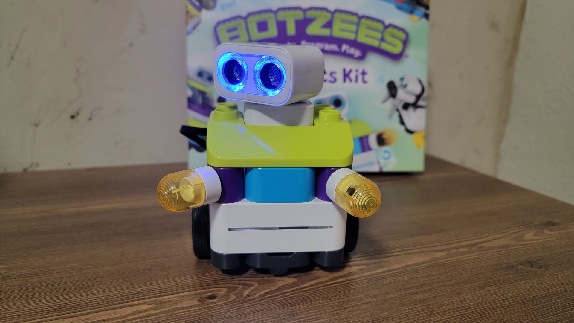 Botzee coding robot sitting up on table