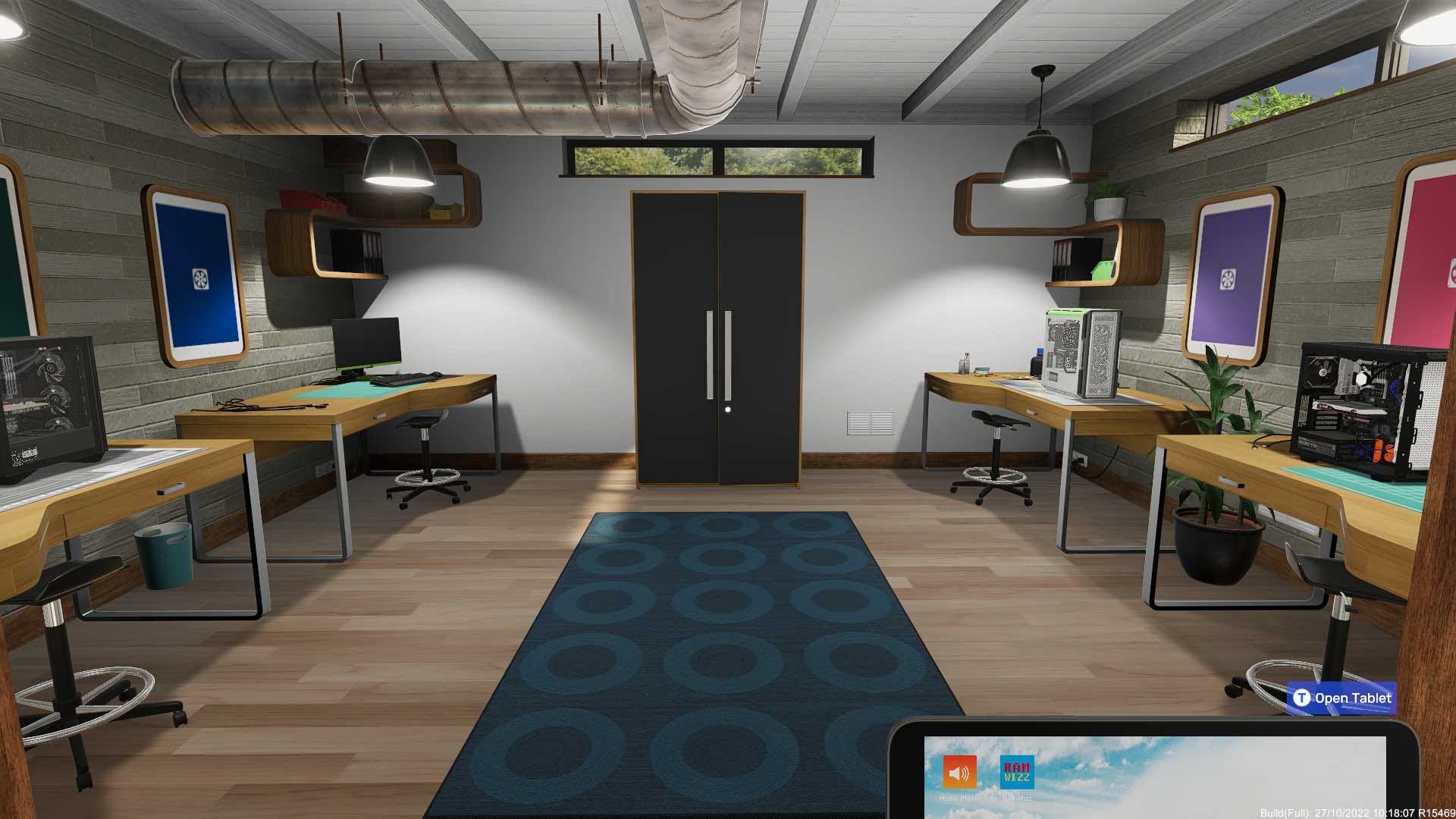 Office space with blue rug, cabinet, and four desks with different components on them.