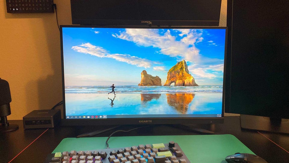 M27F A monitor set with Windows wallpaper next to powered off Armada 25 and NZXT 27Q 