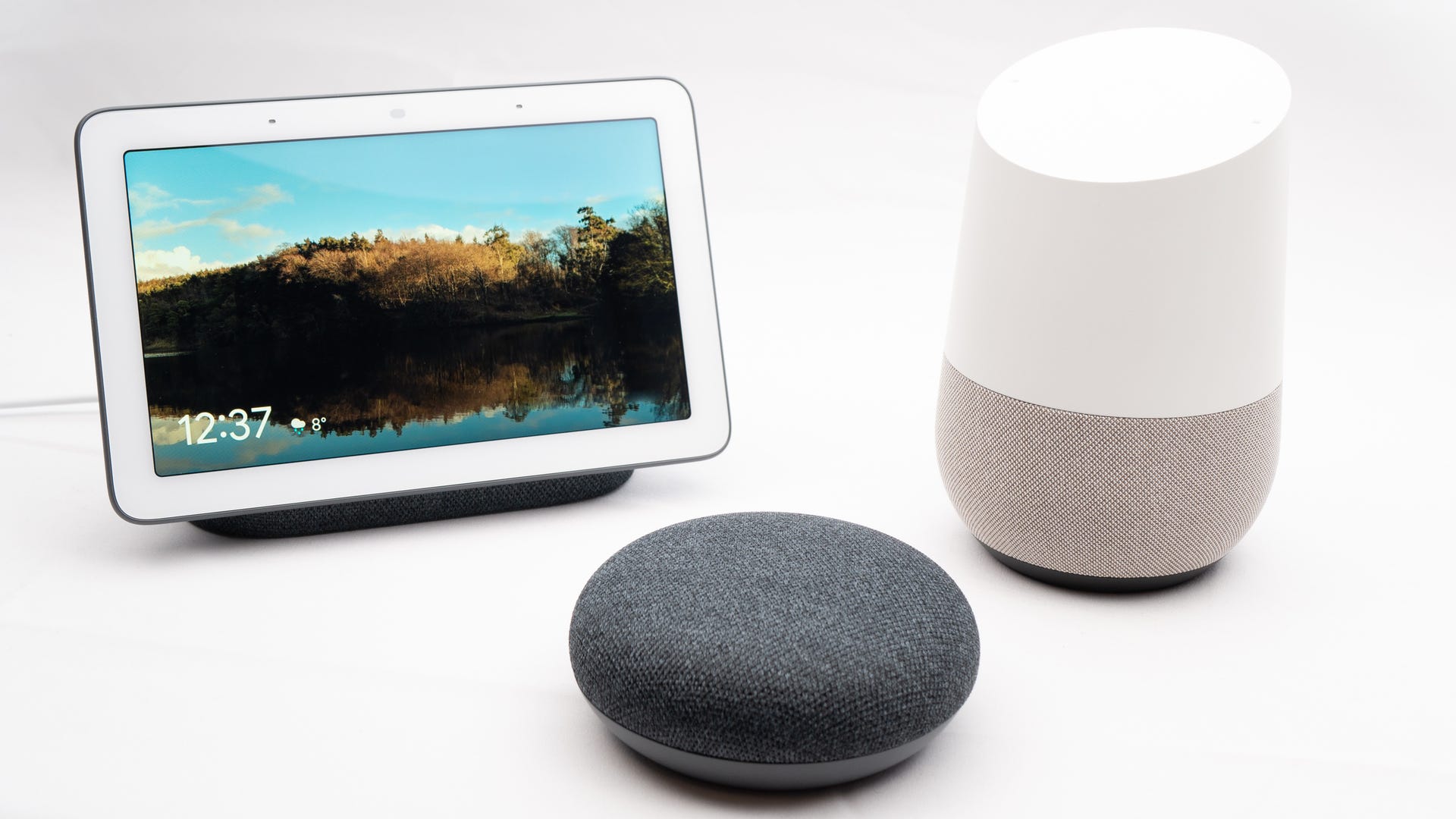 Google Home, Hub, Nest devices together on show in group.