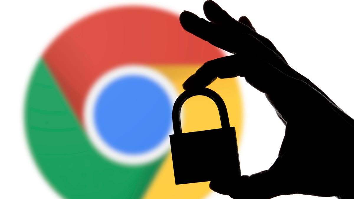 A person holding a padlock in front of a Google Chrome logo
