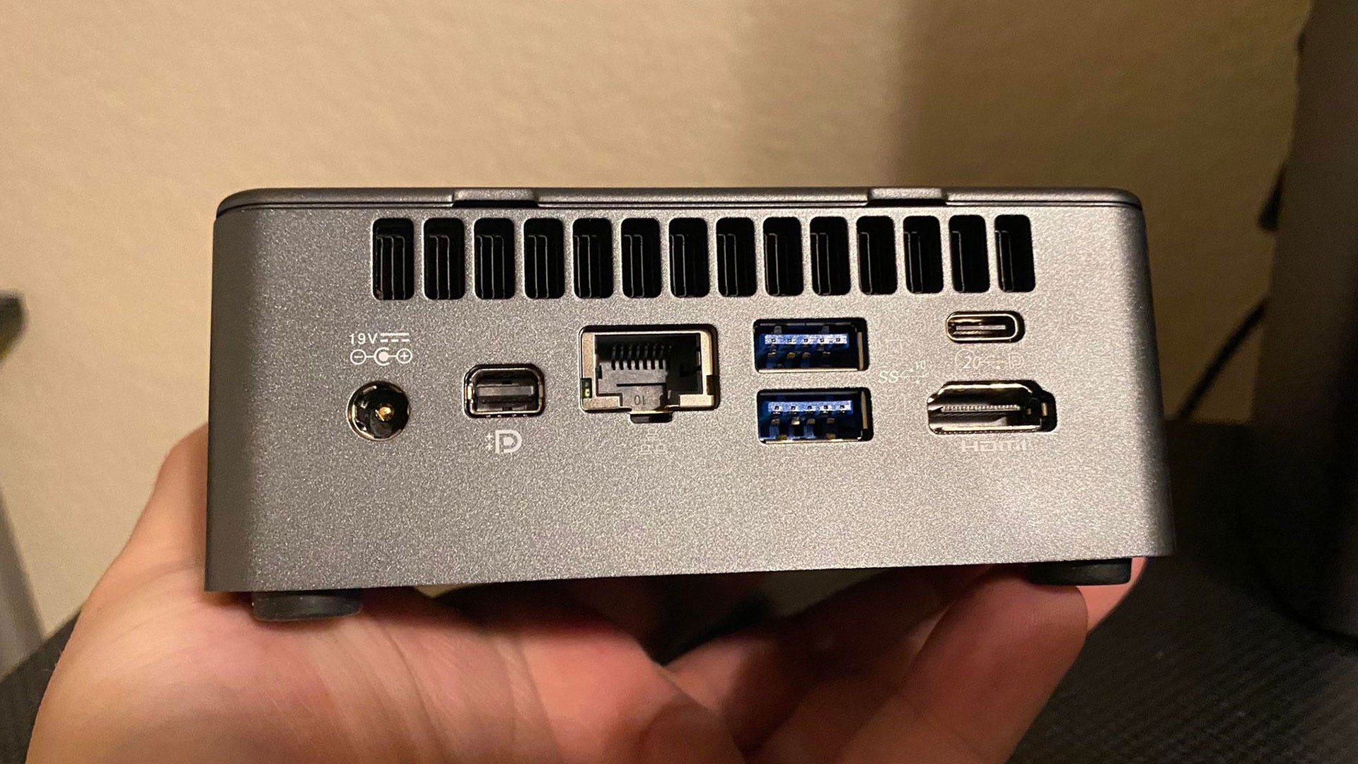 GEEKOM Mini IT11 PC showing back ports, including 2 USB, 1 USB4, 1 HDMI, 1 DisplayPort, and 1 Ethernet