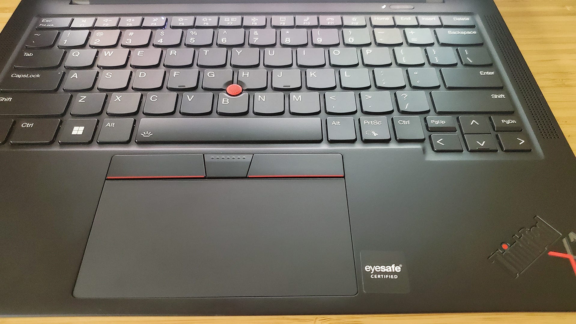 The Lenovo ThinkPad X1 Carbon laptop's trackpad and keyboard.