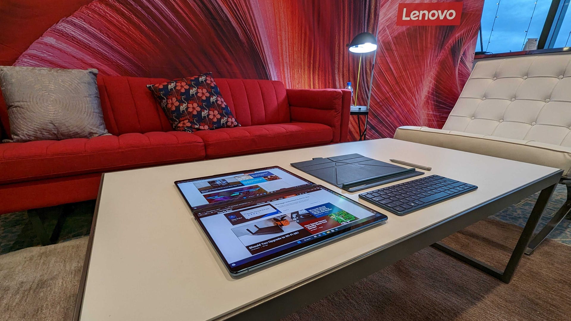 Lenovo Yoga Book 9i laying flat on a table with accessories