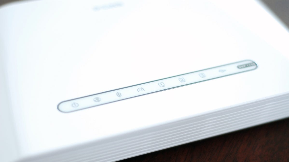 A white router with networking logos visible along the front.