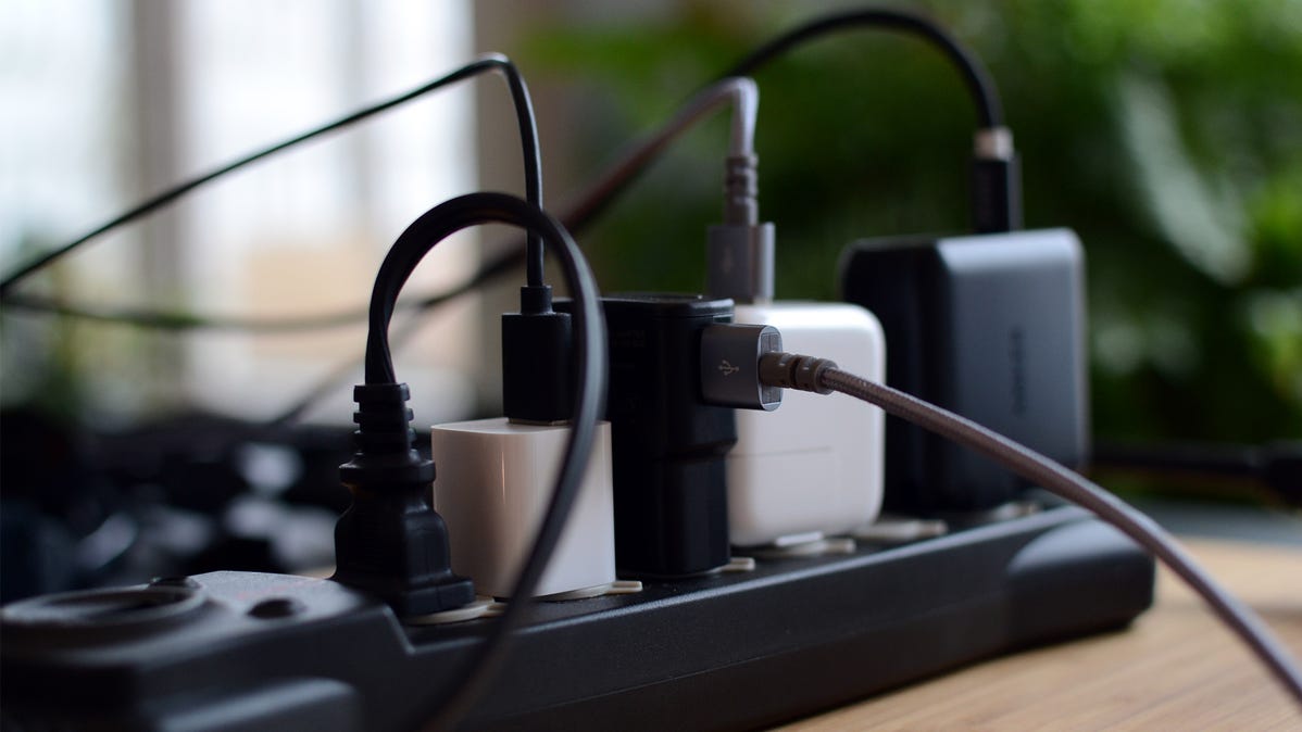A power strip with USB chargers plugged into it.