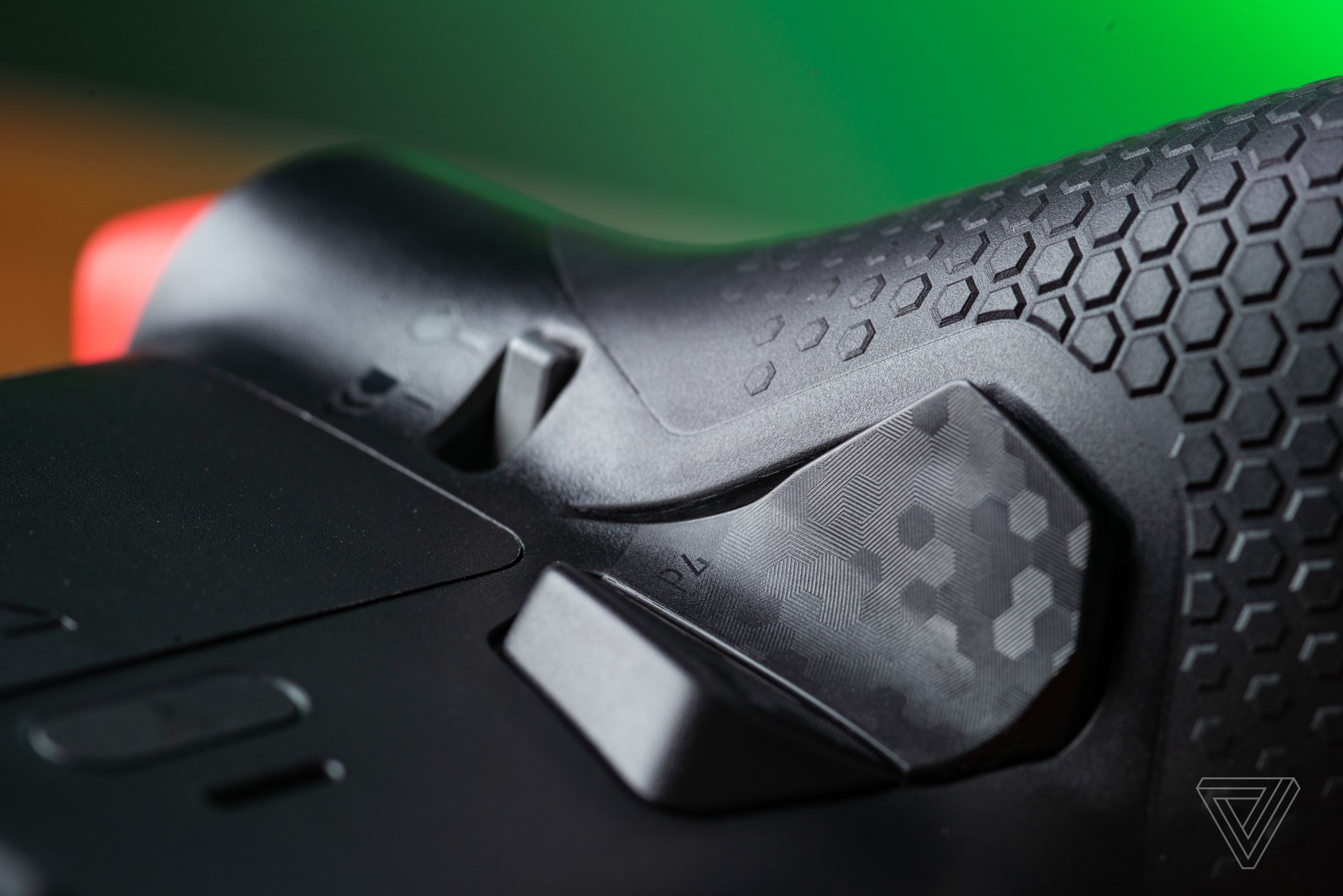 A macro closeup showing the details of the Scuf Instinct Pro’s rear buttons and soft grip texture.