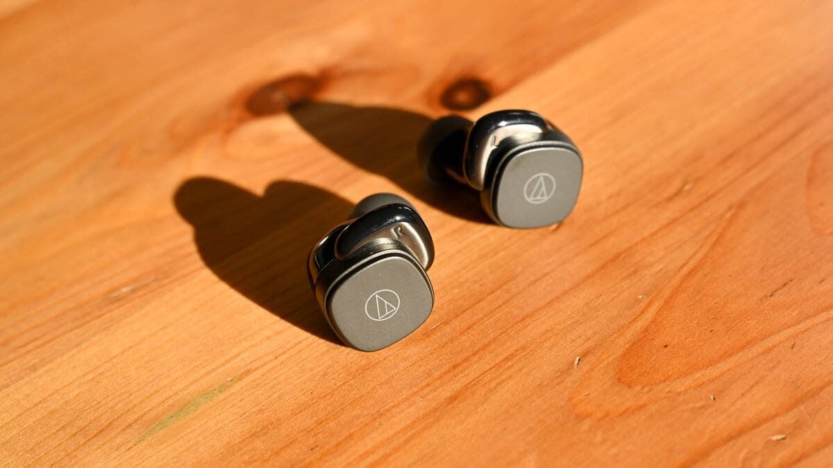two-audio-technica-ath-sq1tw-earbuds-on-a-wood-table-9312281