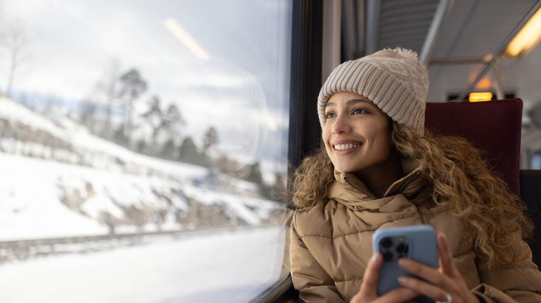 woman in train looking towards the outside window