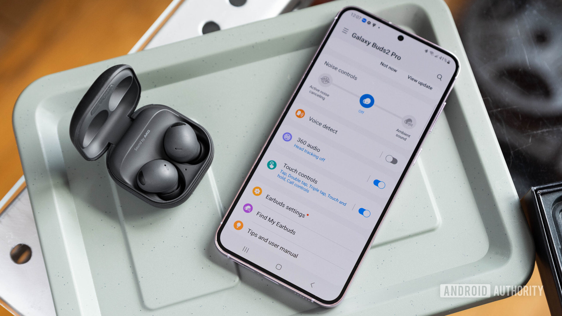 The samsung galaxy buds 2 pro earbuds and case open next to a samsung galaxy buds 23 plus.