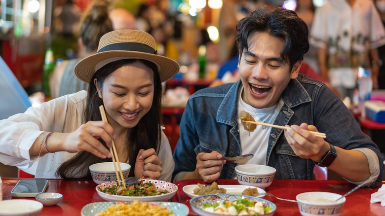 Asian couple eating food