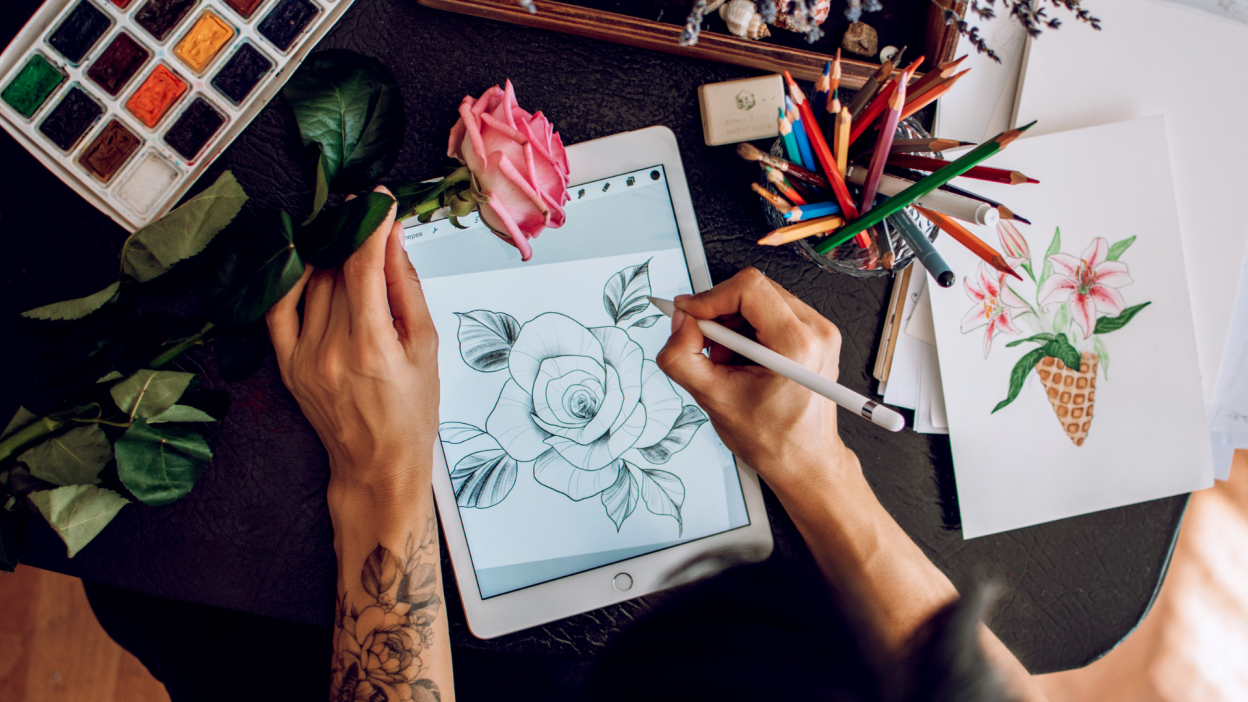 person drawing a flower on an ipad