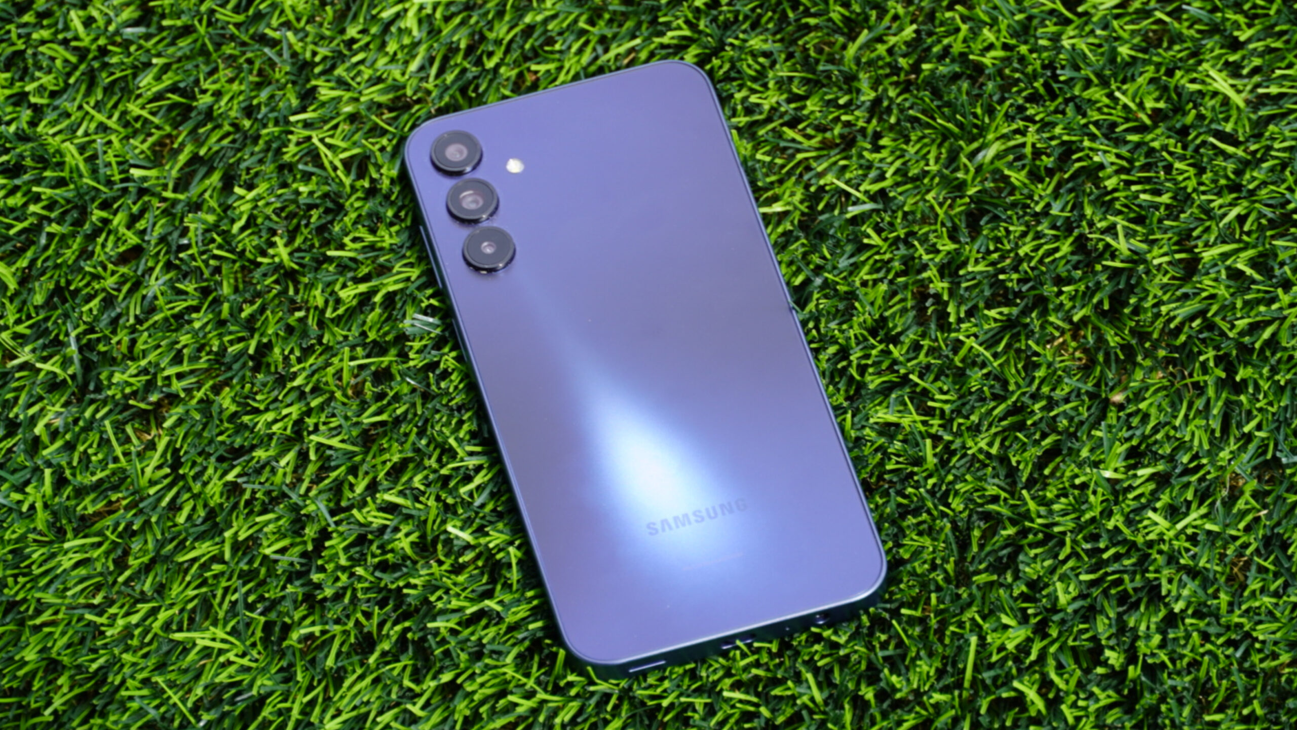 The Samsung Galaxy A15 5G on a patch of grass.