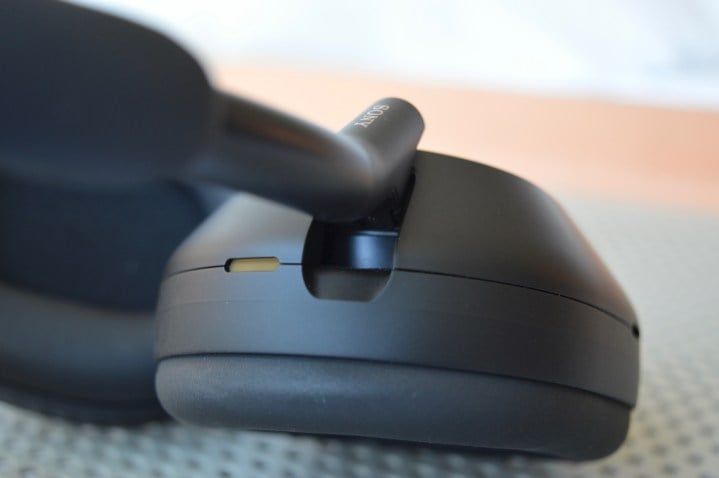Close-up of earcup-pivot on Sony WH-1000XM5 wireless headphones.